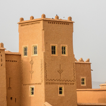 raditional Saudi tower with ochre-colored walls, representing local architecture.